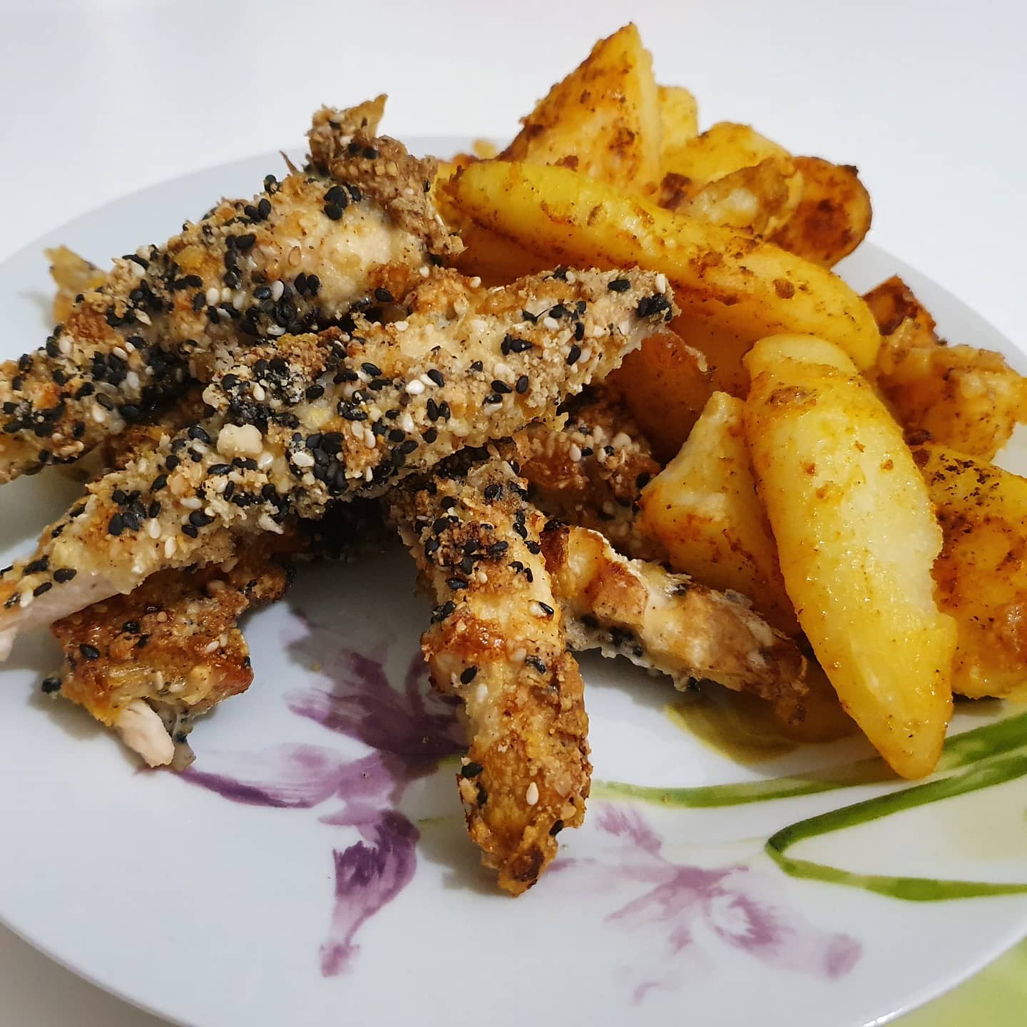 Oven baked schnitzel with corn flakes, sesame seeds and peanuts